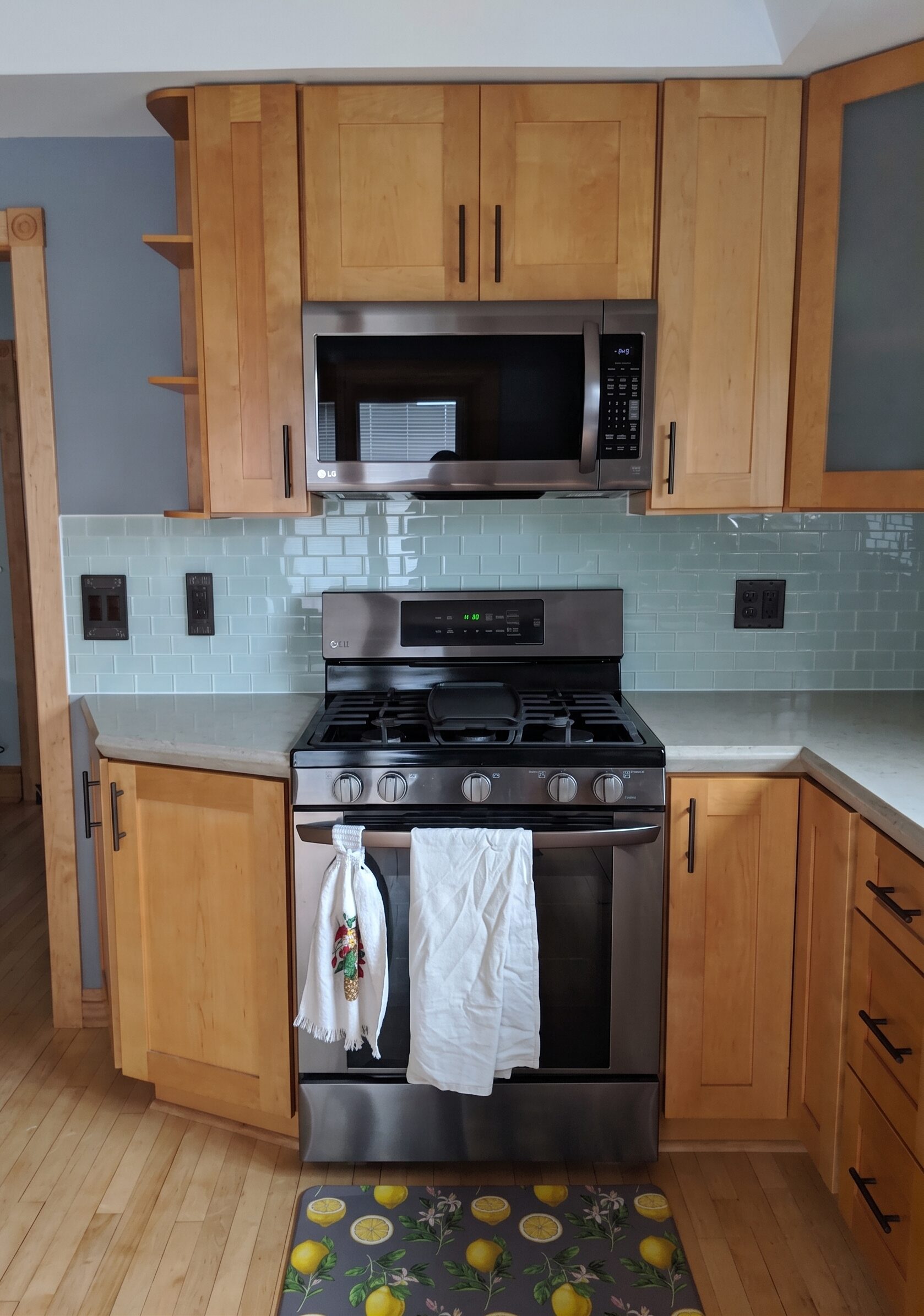 Light green subway tile kitchen backsplash, poured concrete countertops, and maple cabinets installed by Tom Weitenbeck.